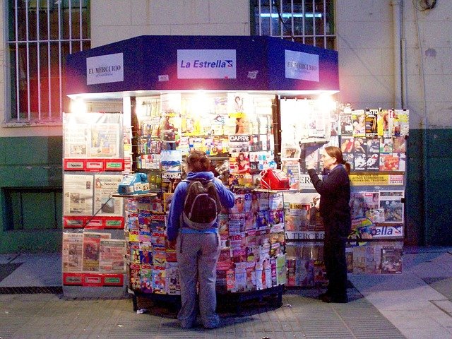 photo of a newstand on the sidewalk